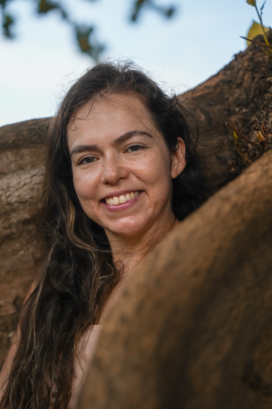Kali smiling warmly outdoors